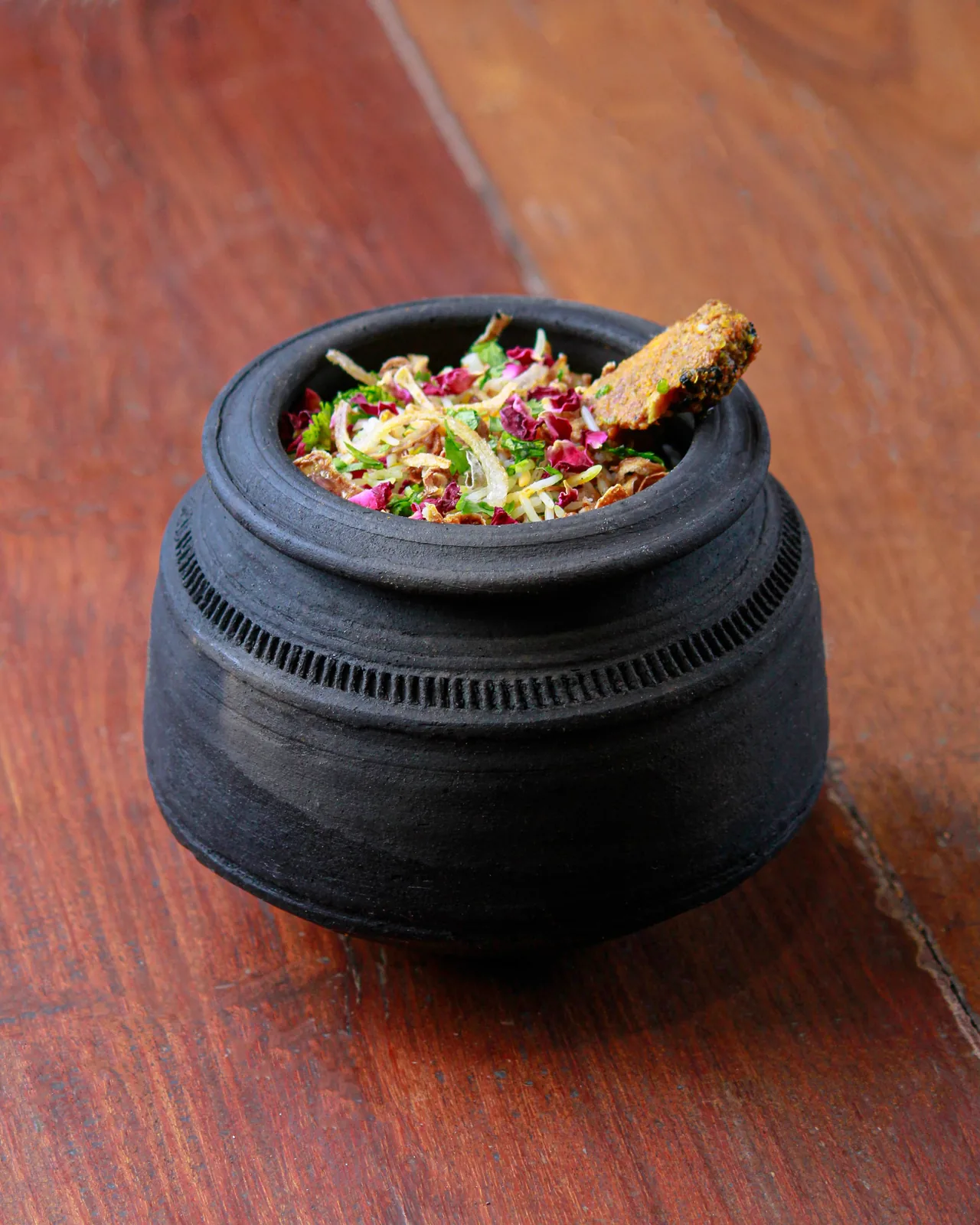 Handi biryani cooked the Lucknowi way — layered, sealed and finished on a gentle coal bed