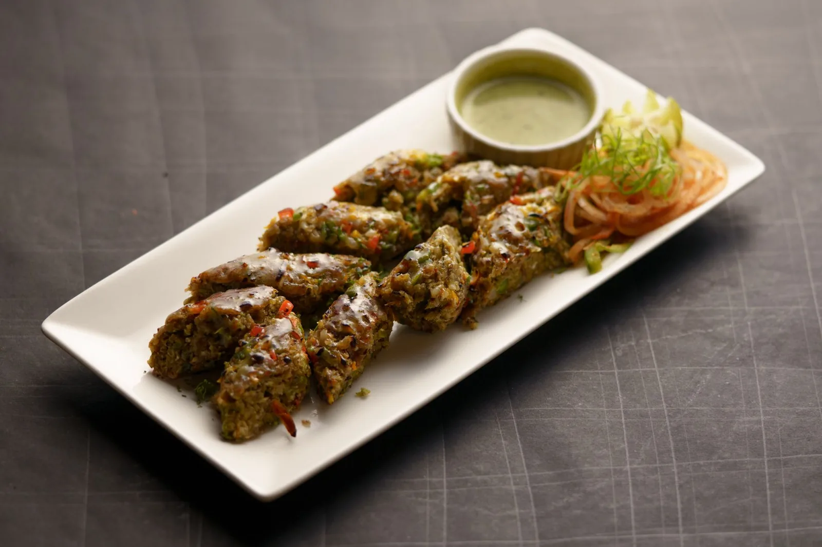 Vegetable kebabs with chutney at a live kebab counter